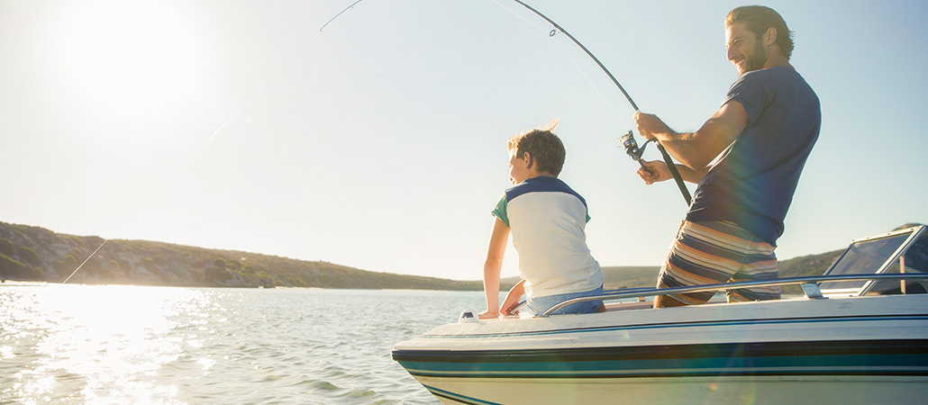 Father and son fishing with small boat insurance.